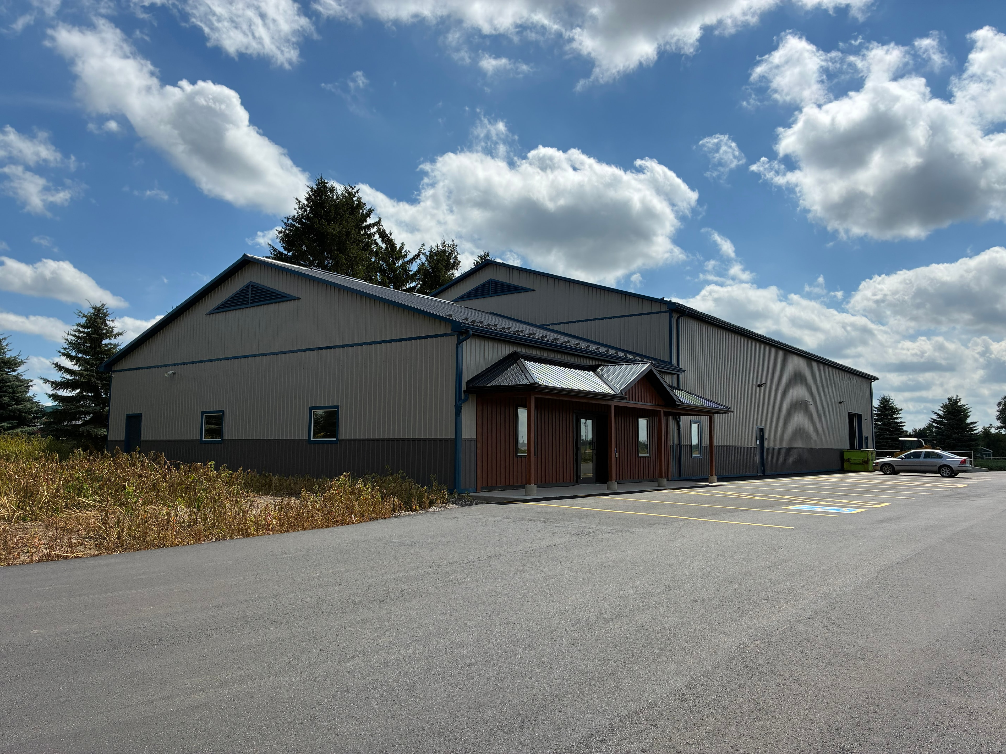 Commercial industrial building with wood-accented entrance canopy and parking lot